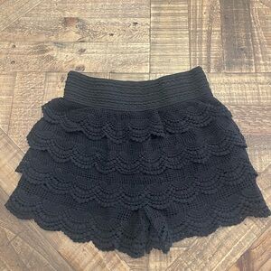 black tiered crochet lace shorts with a smocked waistband.